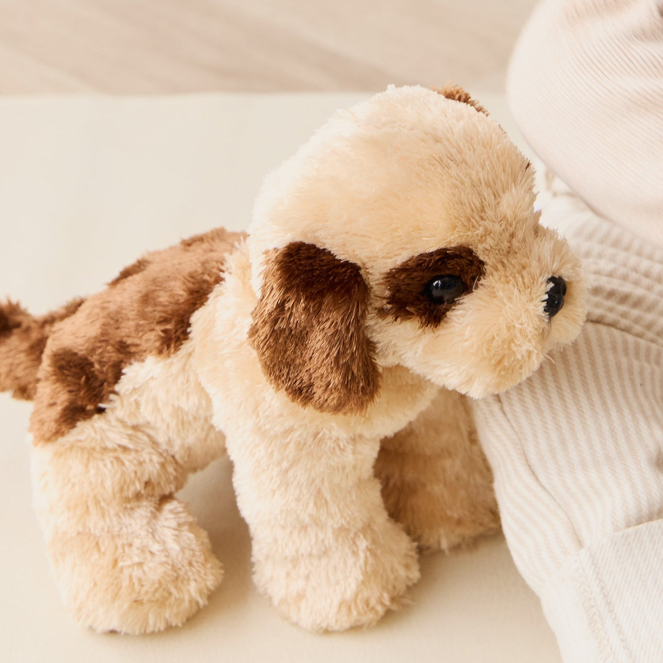 Tan and brown stuffed toy dog.