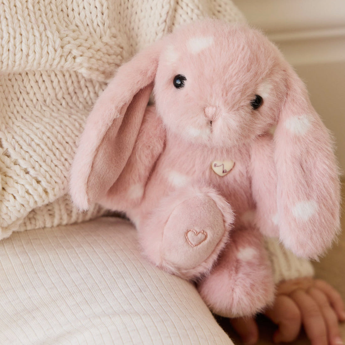 Pink plush rabbit with white hearts.