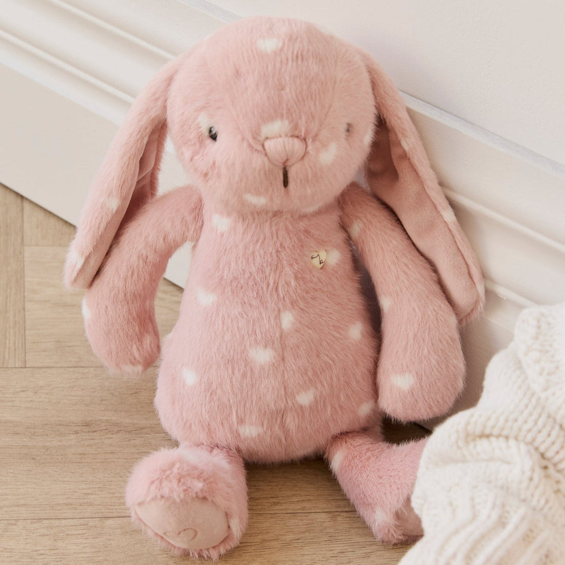 Pink plush rabbit with white hearts.