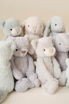 An assortment of plush bunny and bear toys in pastel colors.