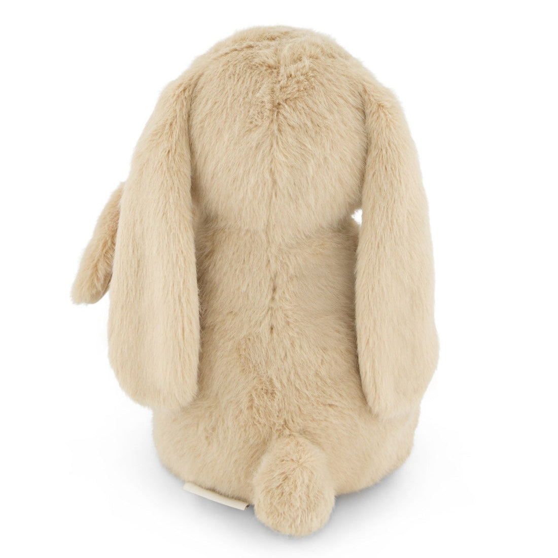 Back view of a beige plush bunny with long, floppy ears and a fluffy tail.