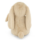 Back view of a beige plush bunny with long, floppy ears and a fluffy tail.
