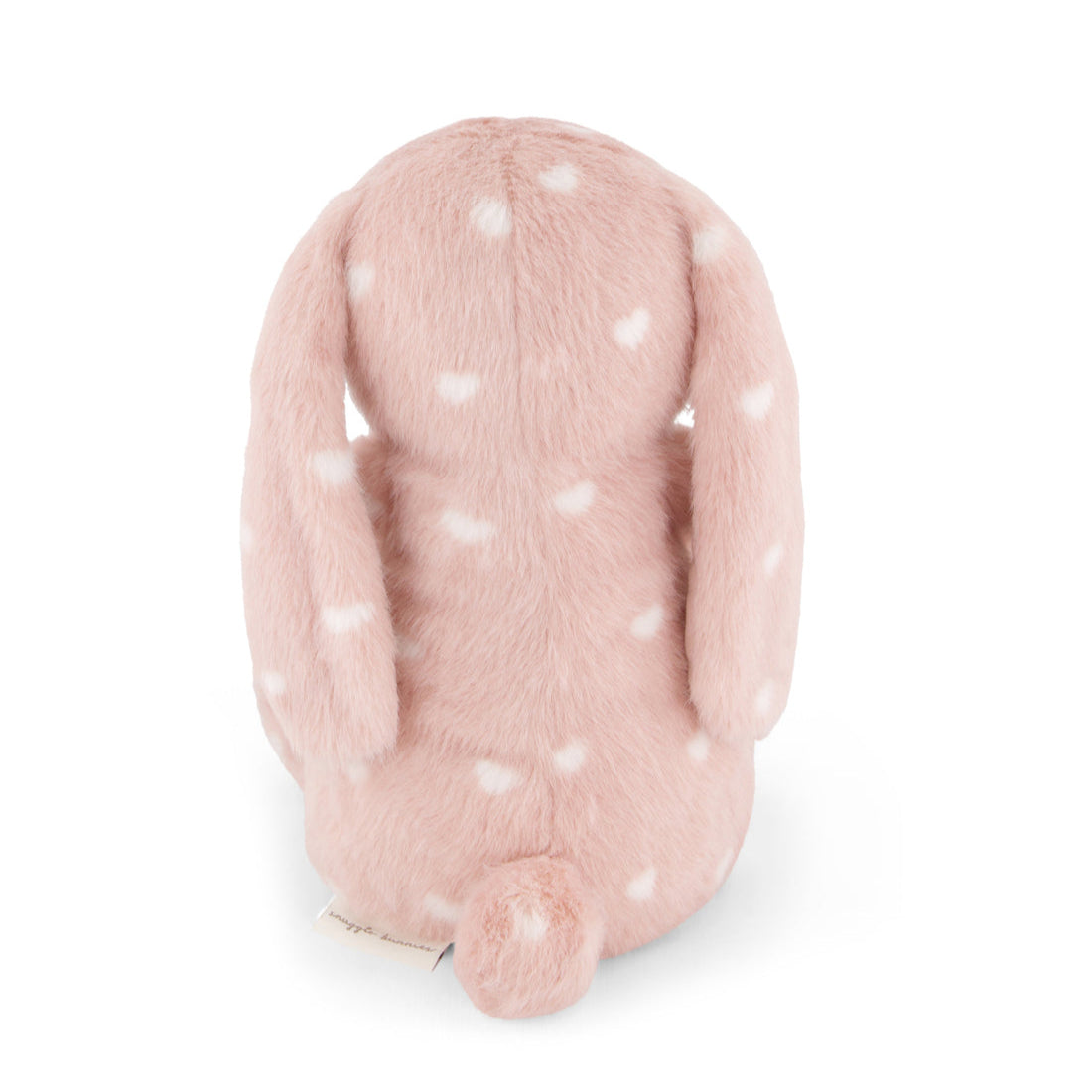 Pink plush rabbit with white heart pattern, back view.