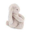 Stuffed gray bunny sitting.