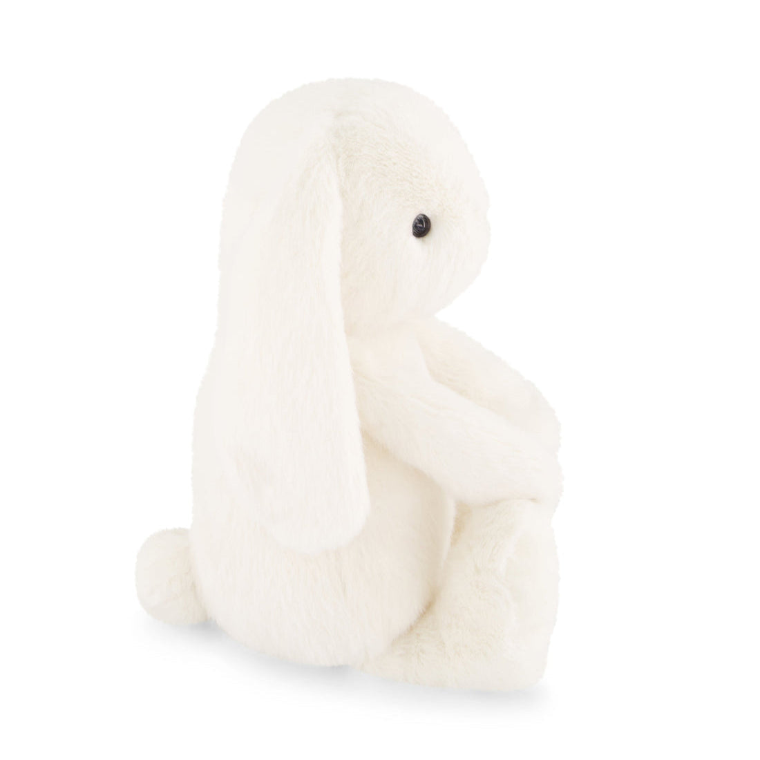 Side view of a fluffy white bunny plush toy sitting upright.