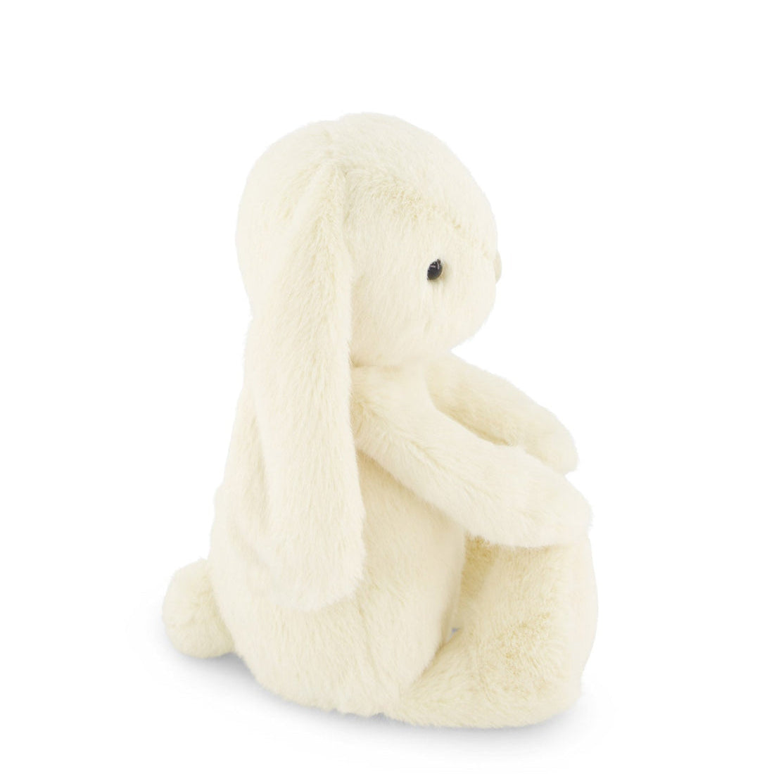 Side view of a cream-colored stuffed bunny with long ears.