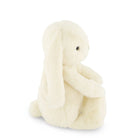 Side view of a cream-colored stuffed bunny with long ears.