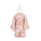 Back of a pink plush rabbit keychain with white heart spots.