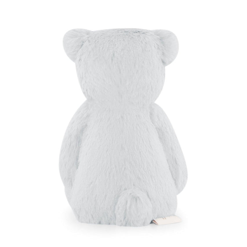Rear view of a light gray plush teddy bear with rounded ears and a small tail.