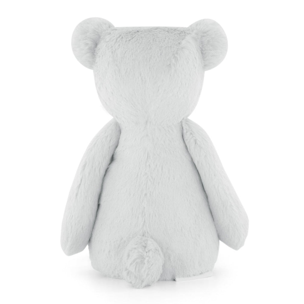 Rear view of a light gray, plush, teddy bear toy.