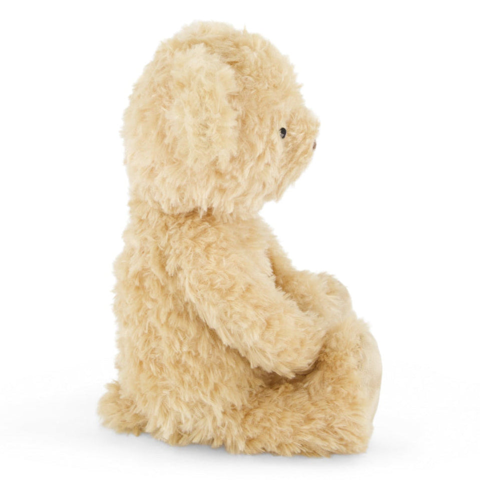 Tan plush bear in profile.