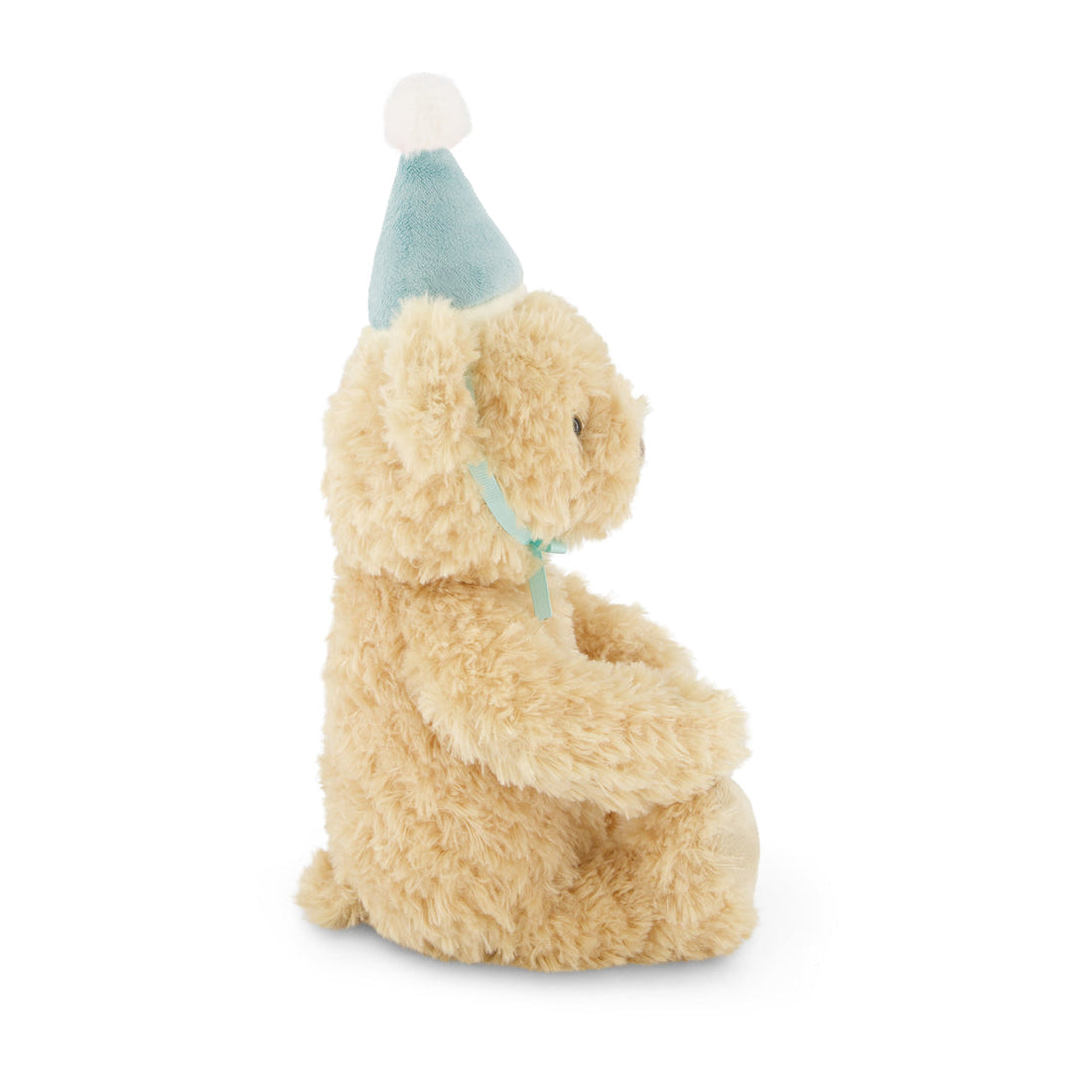 Side view of a tan teddy bear wearing a blue party hat and ribbon.