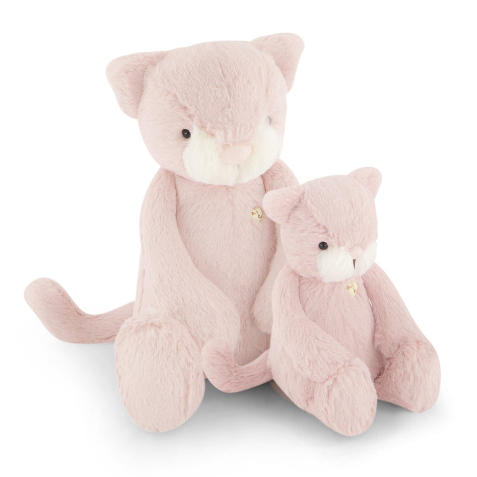 Two pink, plush cat stuffed animals are sitting next to each other.