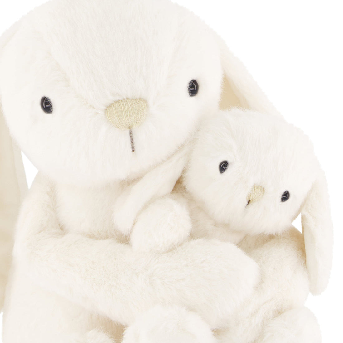 Two cream-colored plush toys, one larger and one smaller, on a white background.