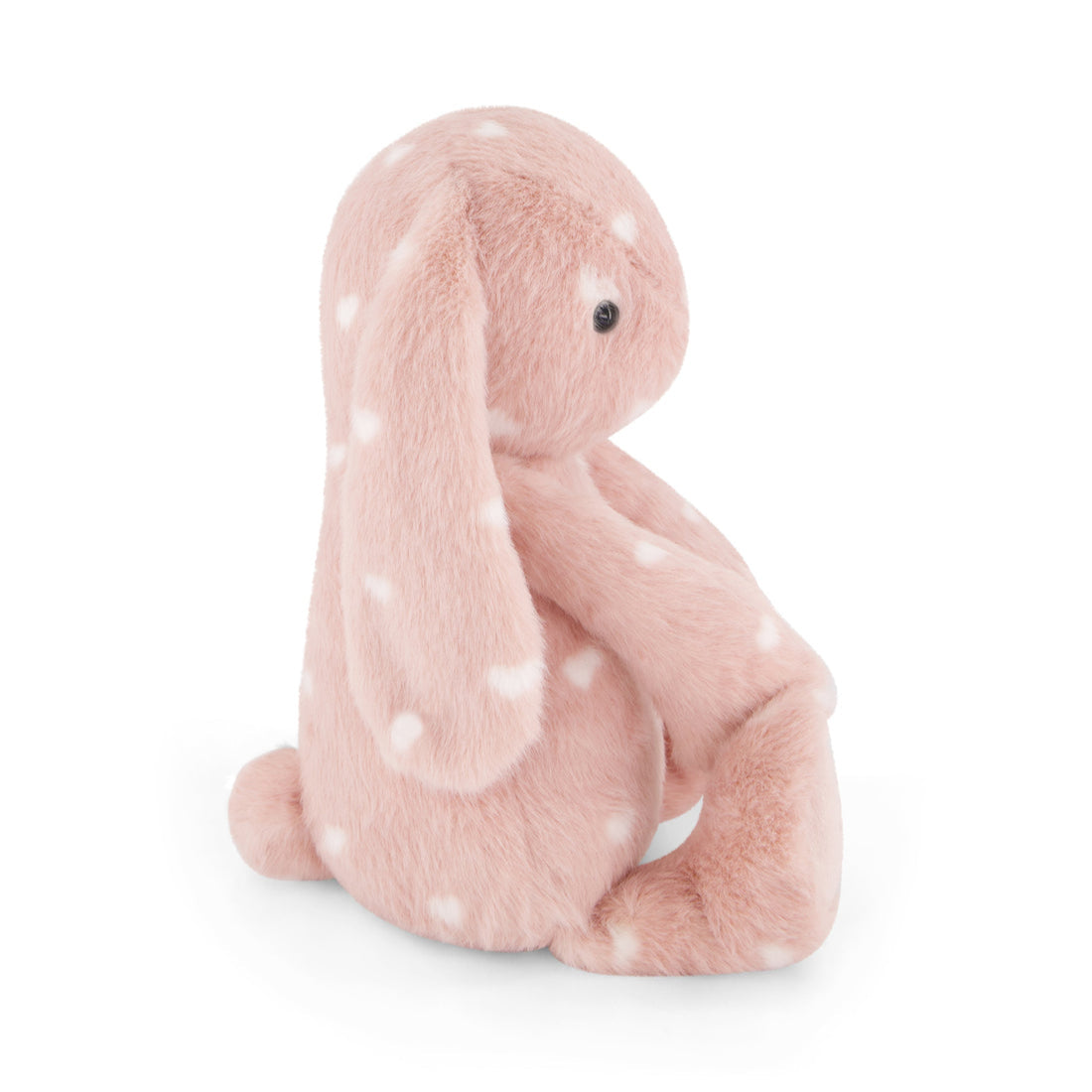 Pink plush bunny toy with white hearts, sitting.