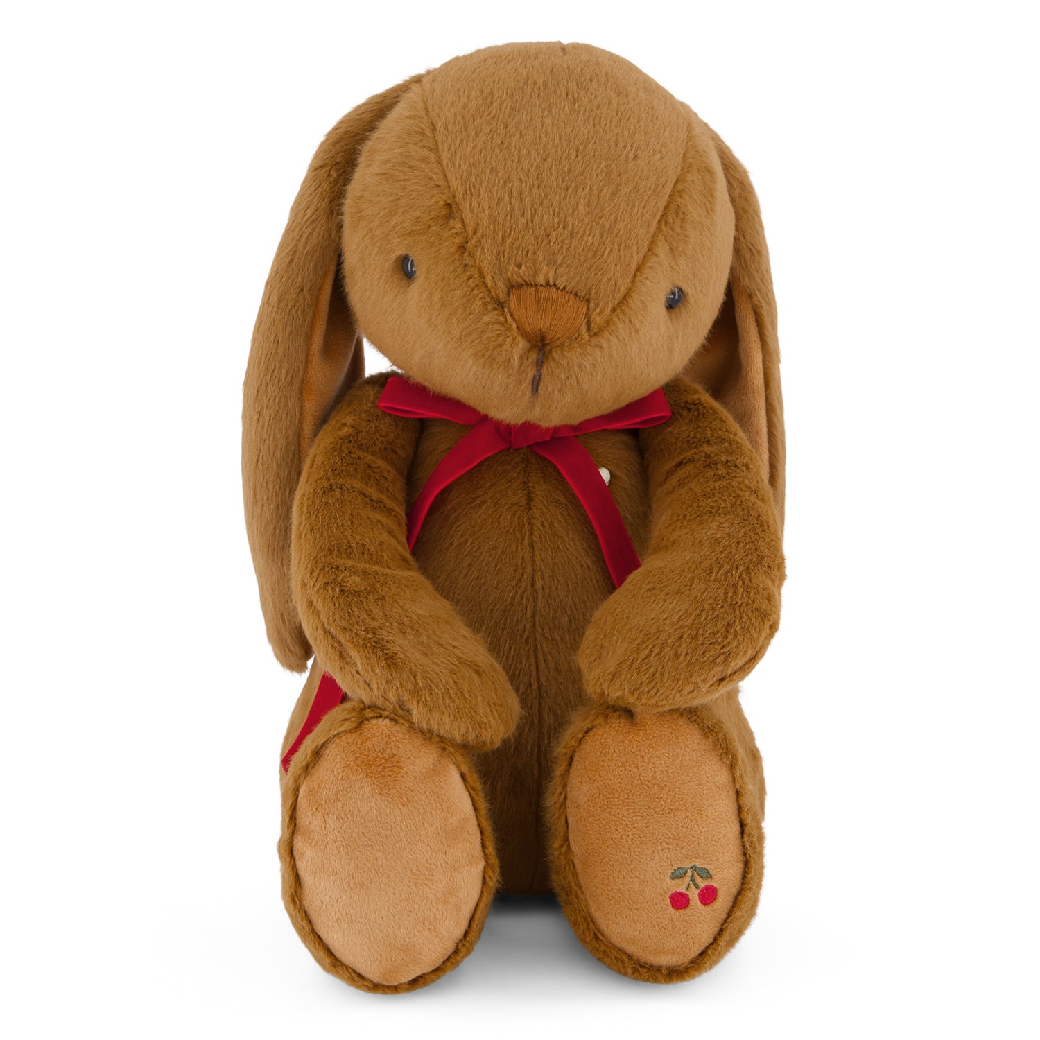 Brown plush bunny with a red bow tie on a white background