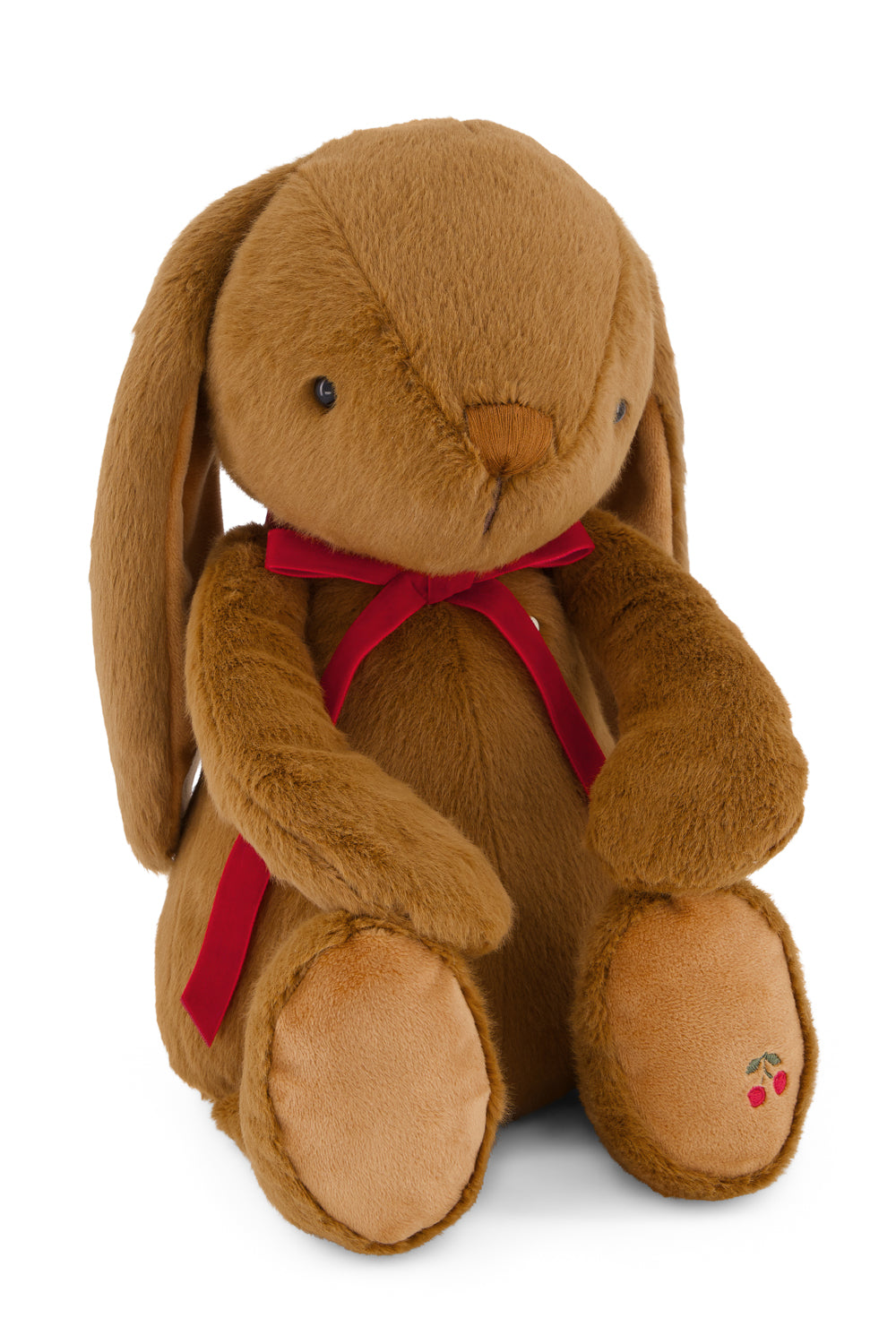 Brown plush bunny with a red bow tie on a white background