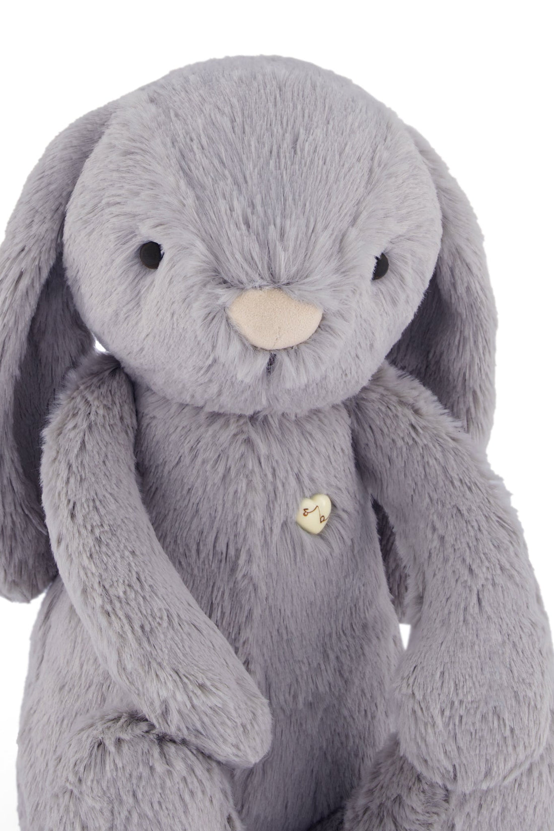 Grey plush bunny with a heart-shaped button.