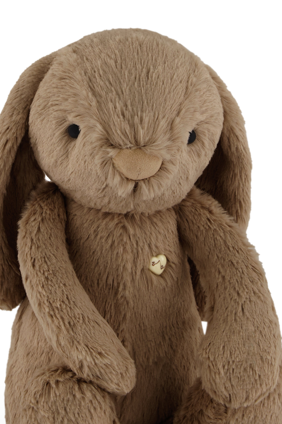Brown plush bunny with a heart-shaped button.