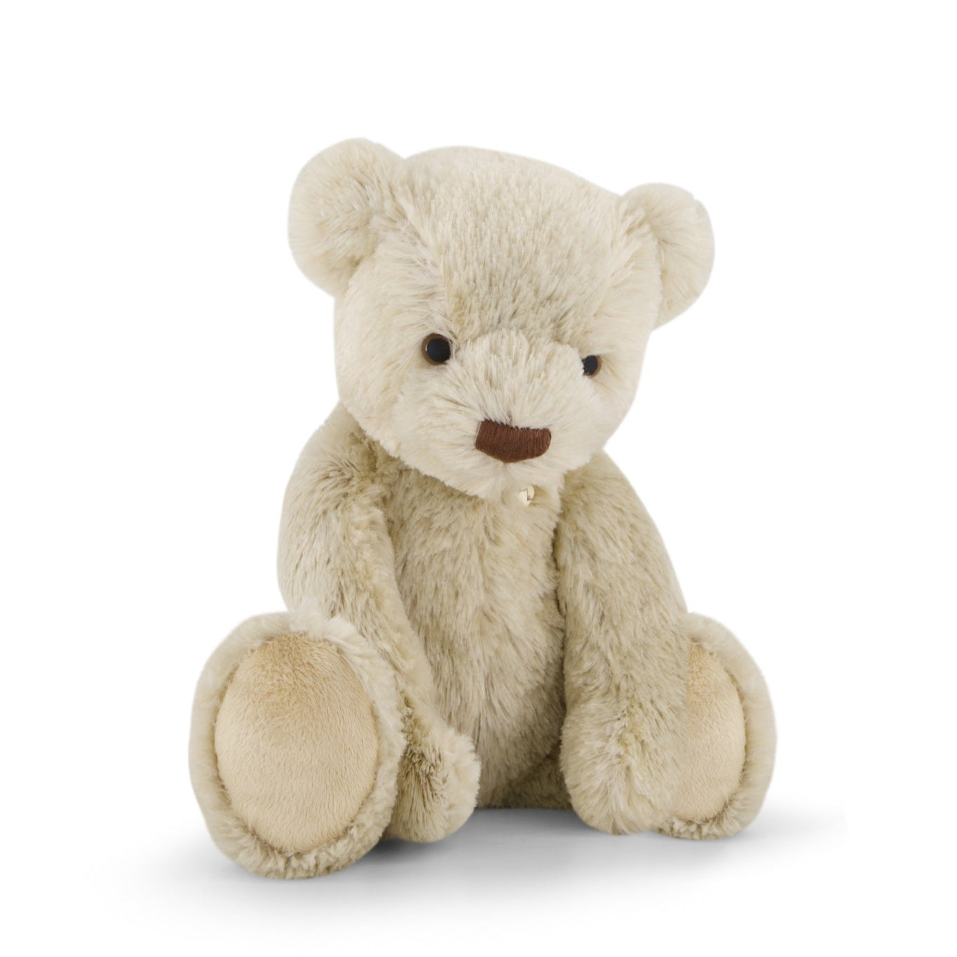 Stuffed beige teddy bear sitting.