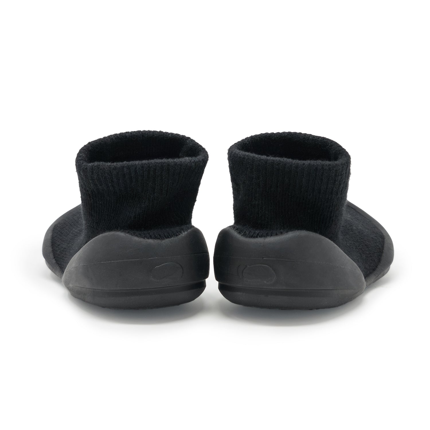 Two black sock shoes with rubber soles.