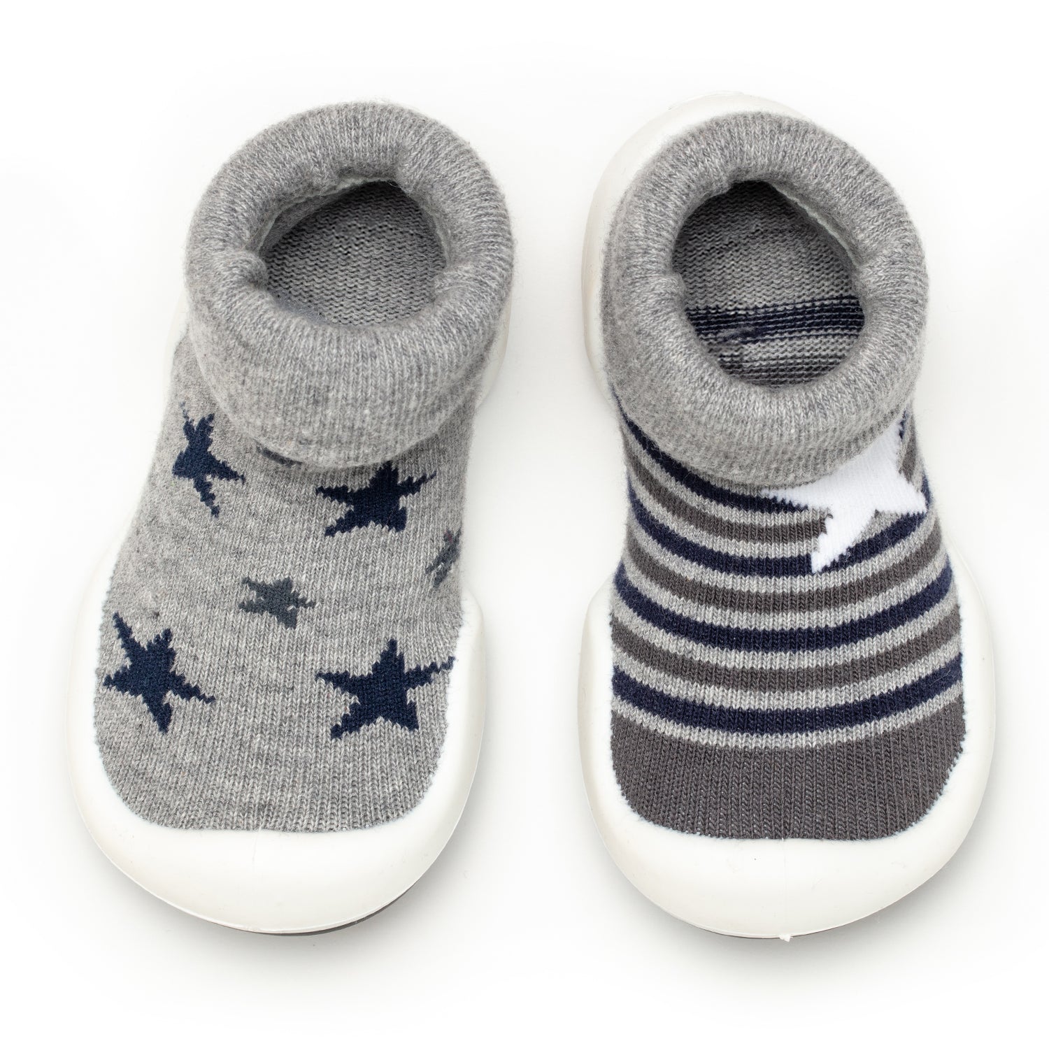 Two baby shoe socks, one with blue stars, the other with grey and blue stripes and a white star.