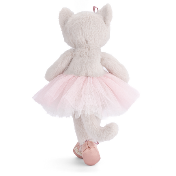 Plush toy cat in a pink tutu and ballet shoes on a white background
