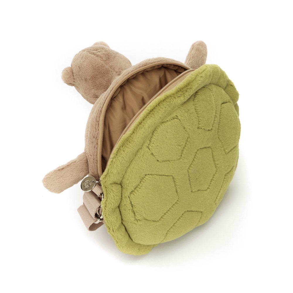 Stuffed animal turtle backpack with green shell and beige straps.