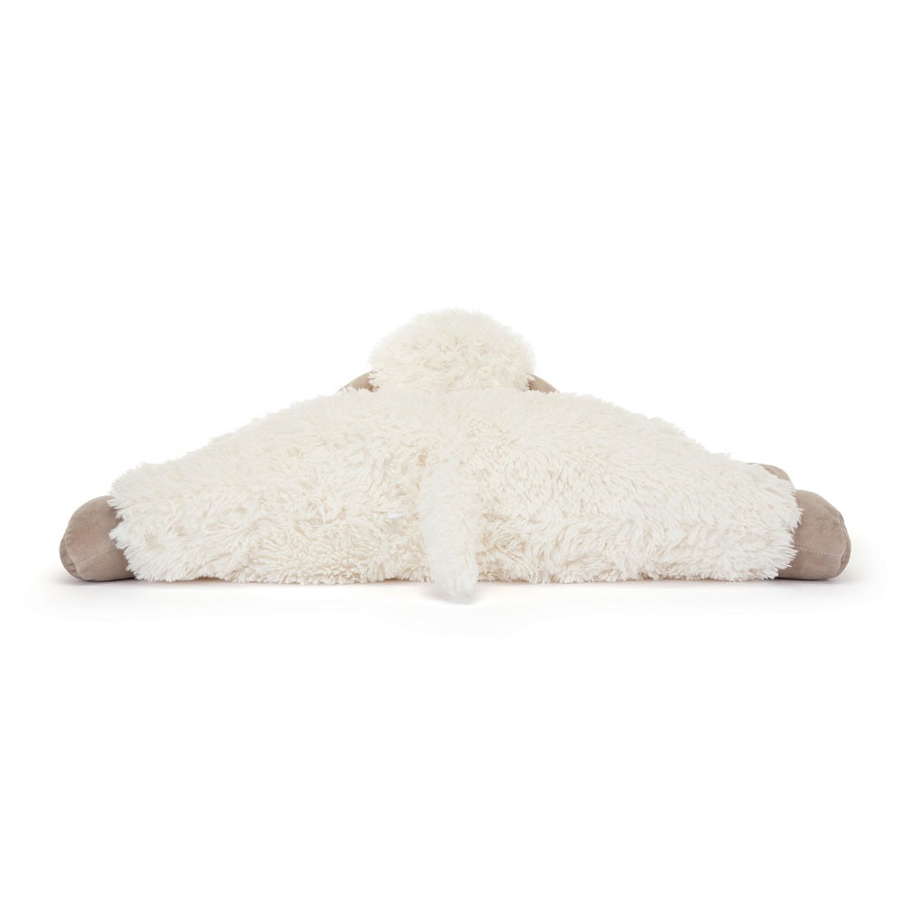 Rear view of a white plush sheep toy with tan extremities laying flat on a white surface.