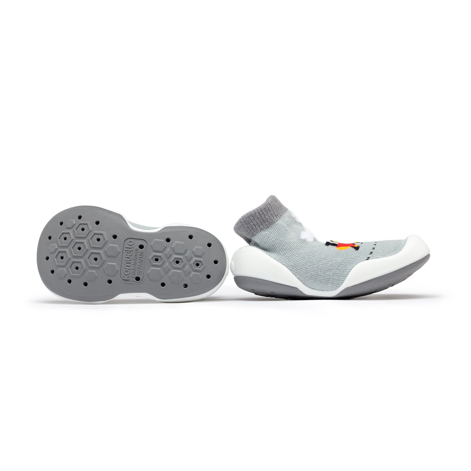 Pair of gray baby sock shoes with white soles.