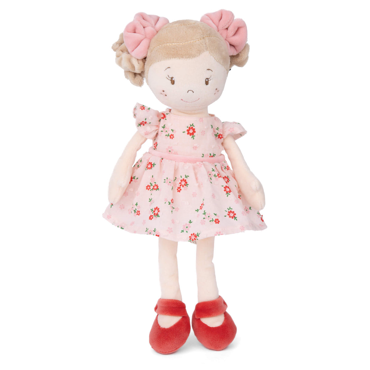 Stuffed doll with a pink floral dress and red shoes on a white background
