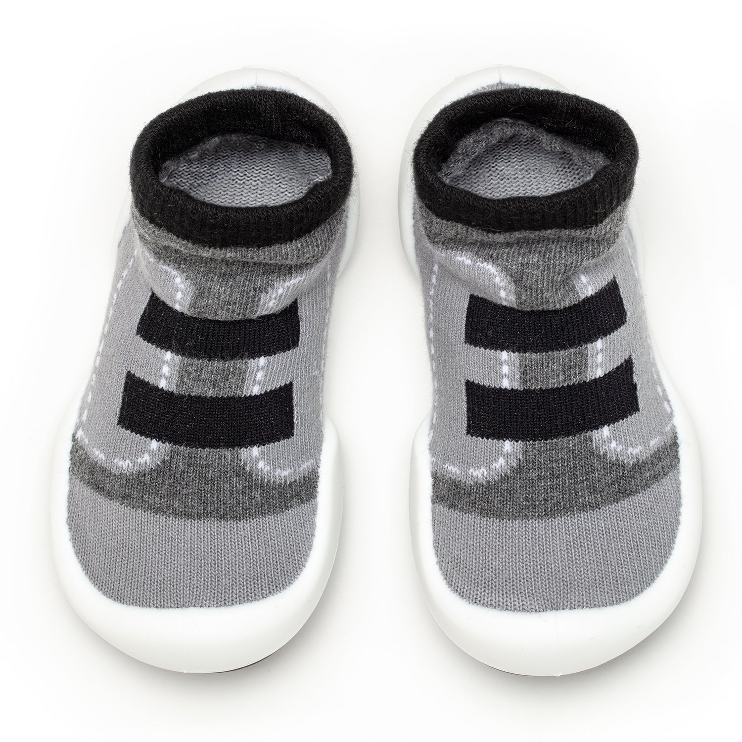 A pair of gray and black baby sock-shoes with white soles.