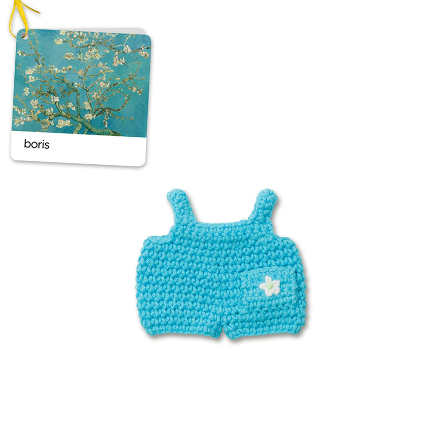 Crocheted blue doll romper with flower.