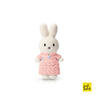 Crocheted white Miffy bunny toy wearing a pink dress.