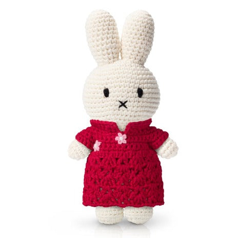 Crocheted Miffy bunny wearing a red dress.