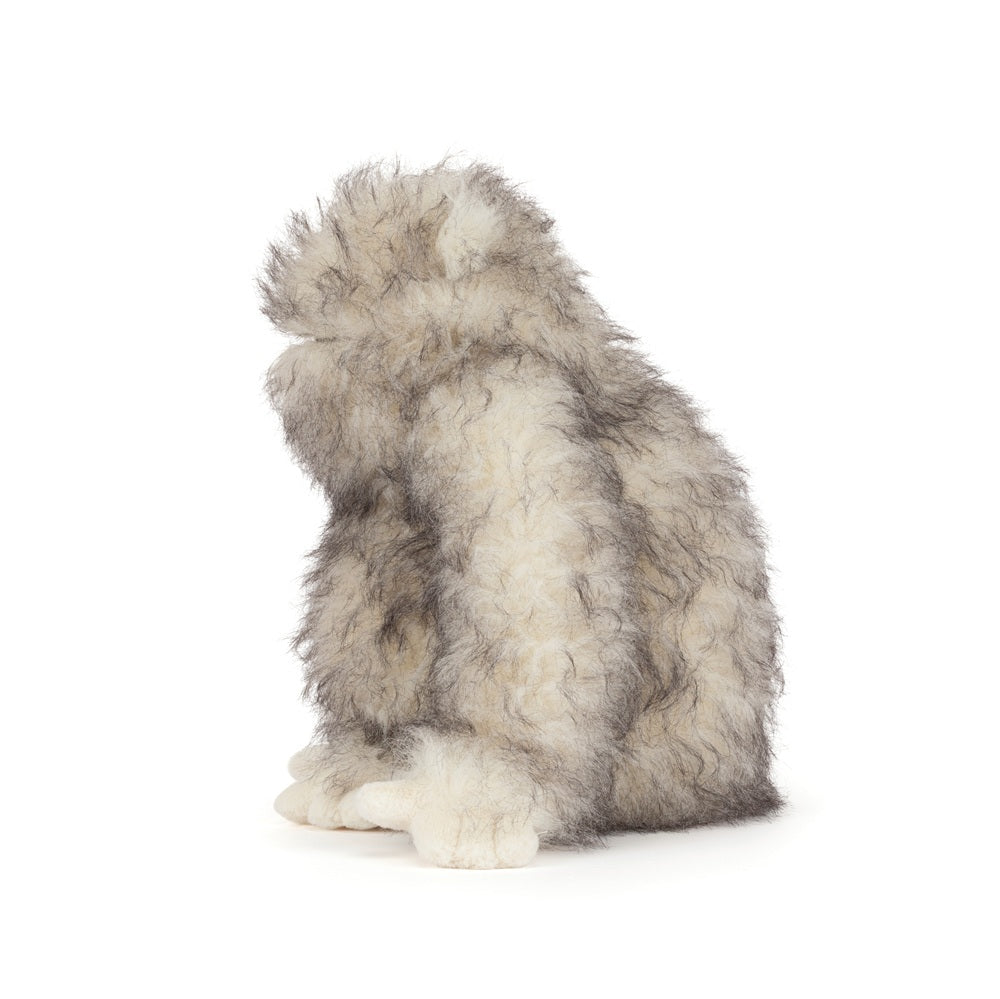 Plush toy resembling a wolf on a white background