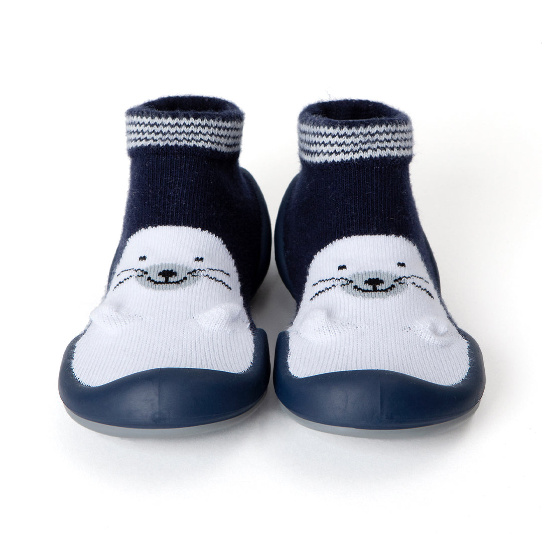 Navy blue and white baby shoe socks with seal face.