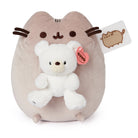 Pusheen plush holding a white teddy bear.