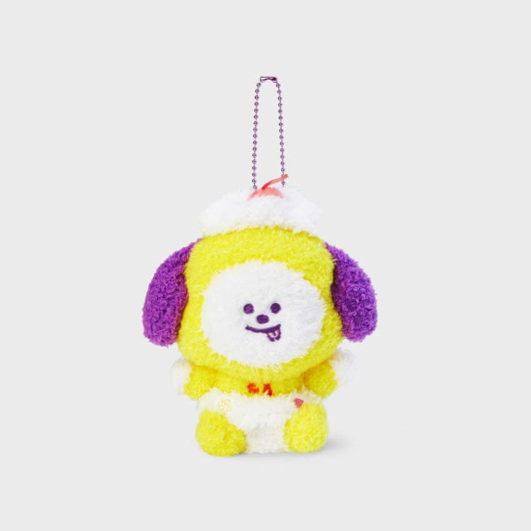 Plush yellow and white dog toy with purple ears, wearing a white and red hat and diaper, with a silver chain.