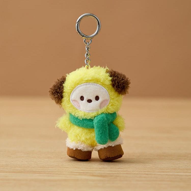 Plush yellow dog keychain with green scarf.