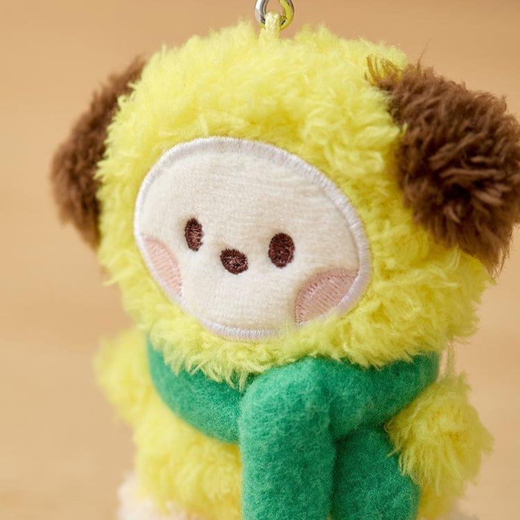 Plush yellow dog wearing a green scarf.