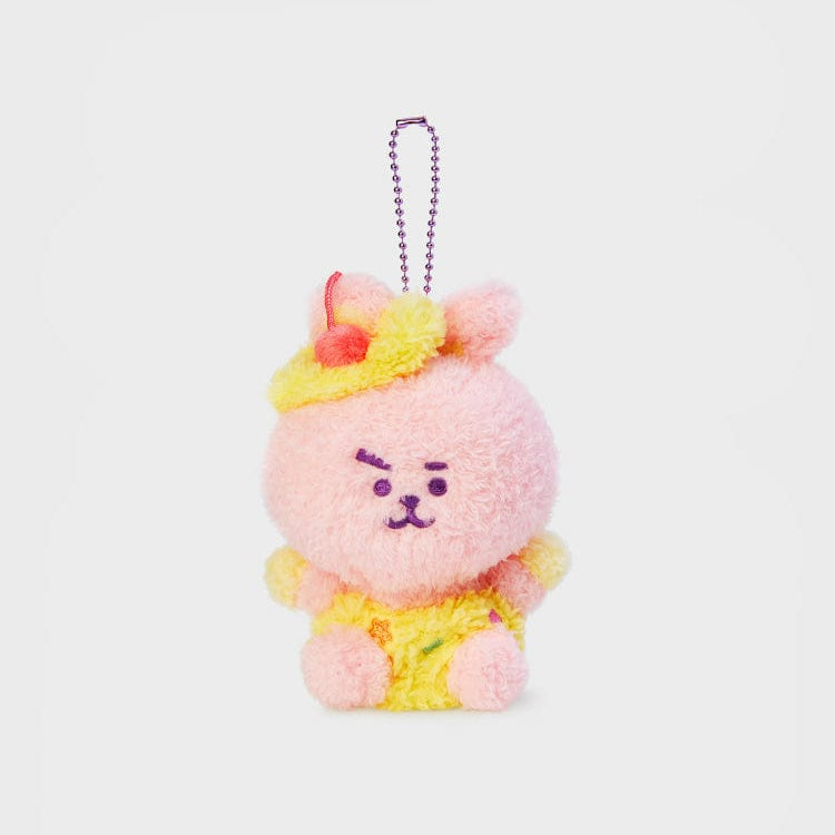 Pink plush rabbit wearing a yellow hat and overalls with a purple ball chain.