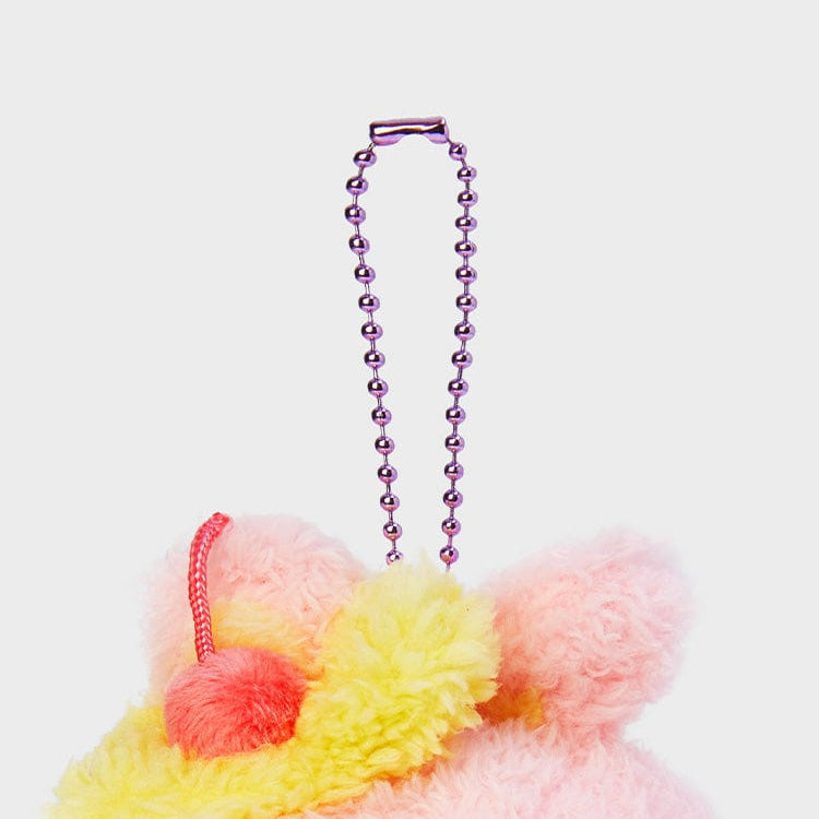 Close up of a pink and yellow plush keychain with a metal chain.