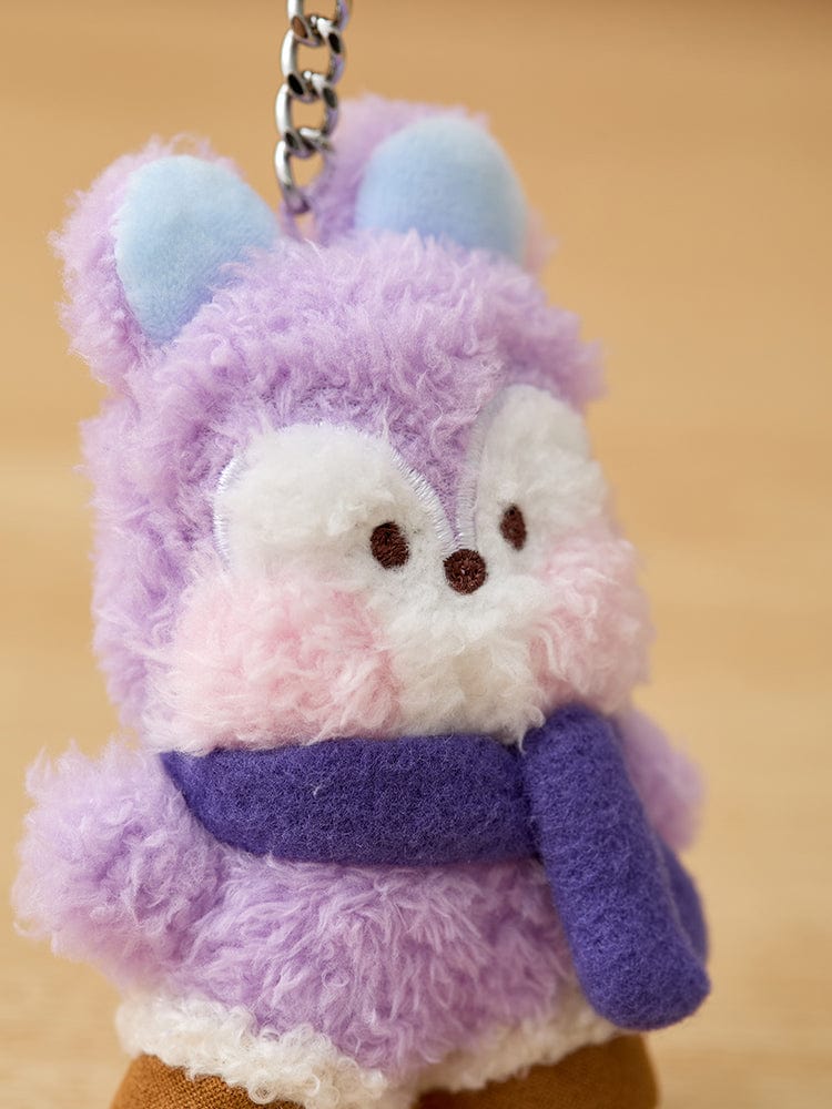 Close up of a purple and white plush keychain animal with a purple scarf.