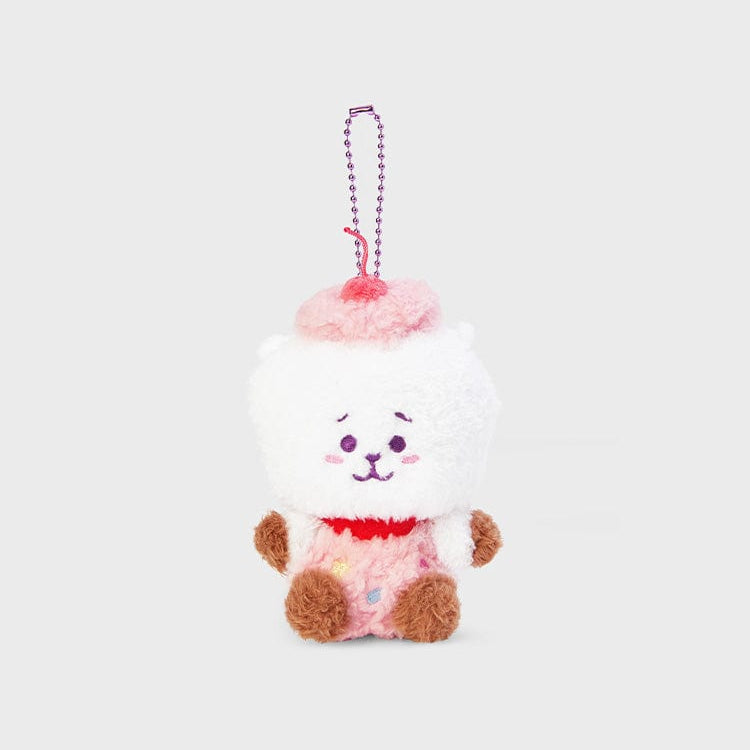Plush white bear in pink cupcake costume with cherry on top.