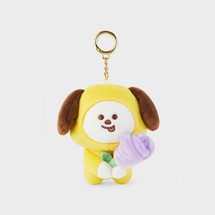 Yellow plush Chimmy keyring holding a purple flower.