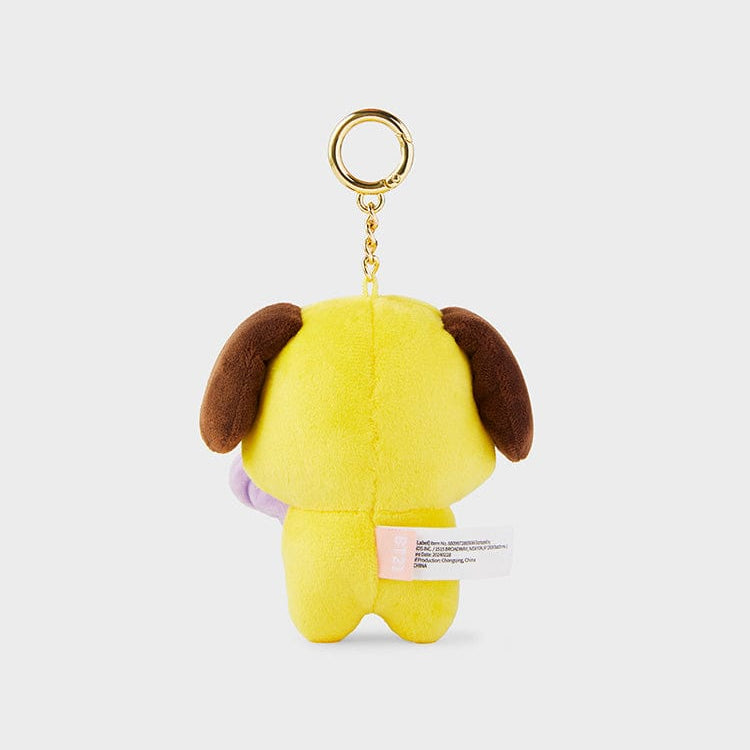 Back of a yellow plush keychain with brown ears.
