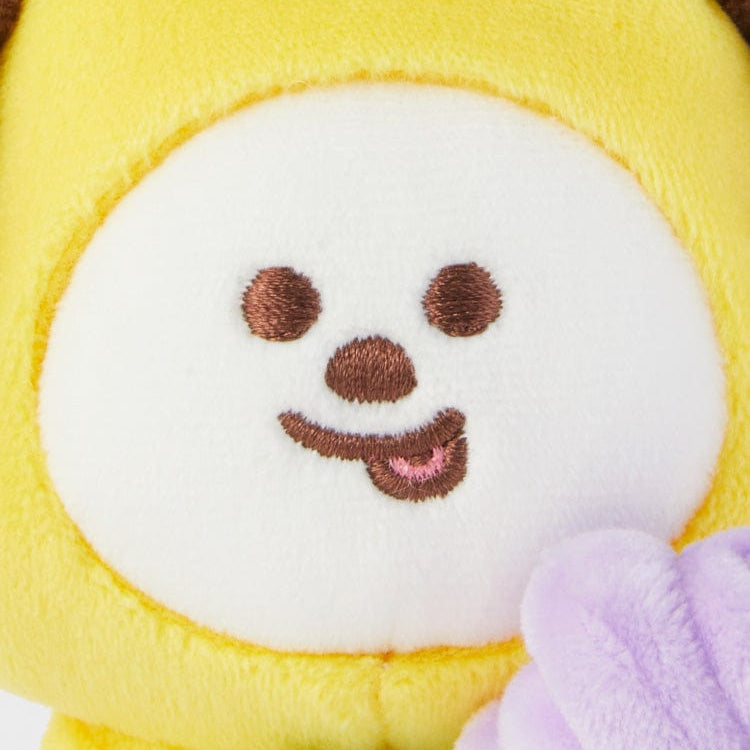 Yellow plush toy with embroidered facial features.