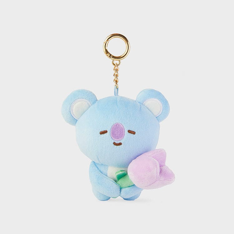 Light blue stuffed koala keychain with a gold ring, chain, and a pink tulip.