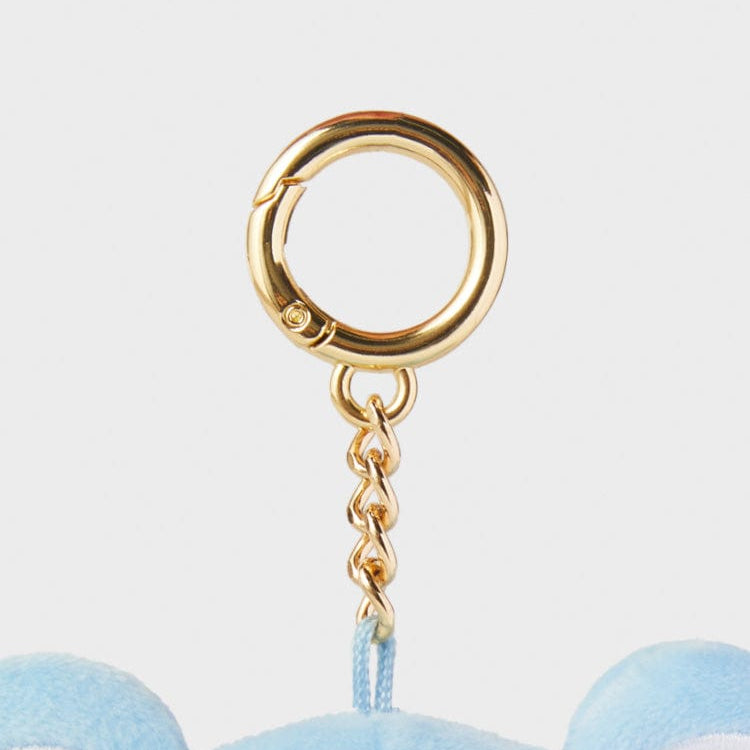 Gold keychain with blue fabric.